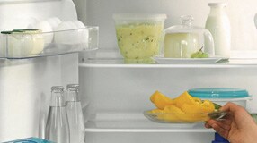 Woman opening fridge